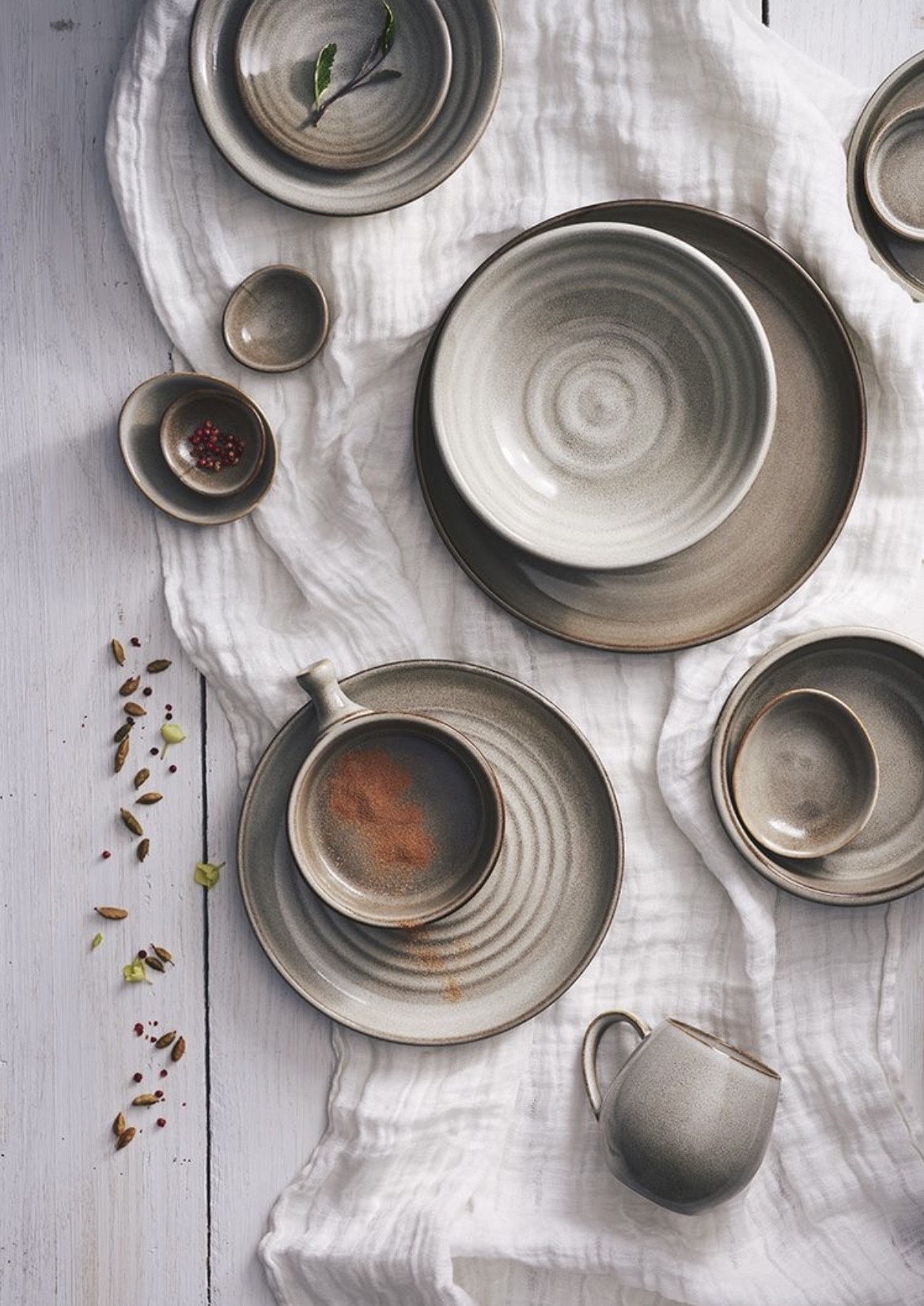 Hand-thrown stoneware on soft linen with spices