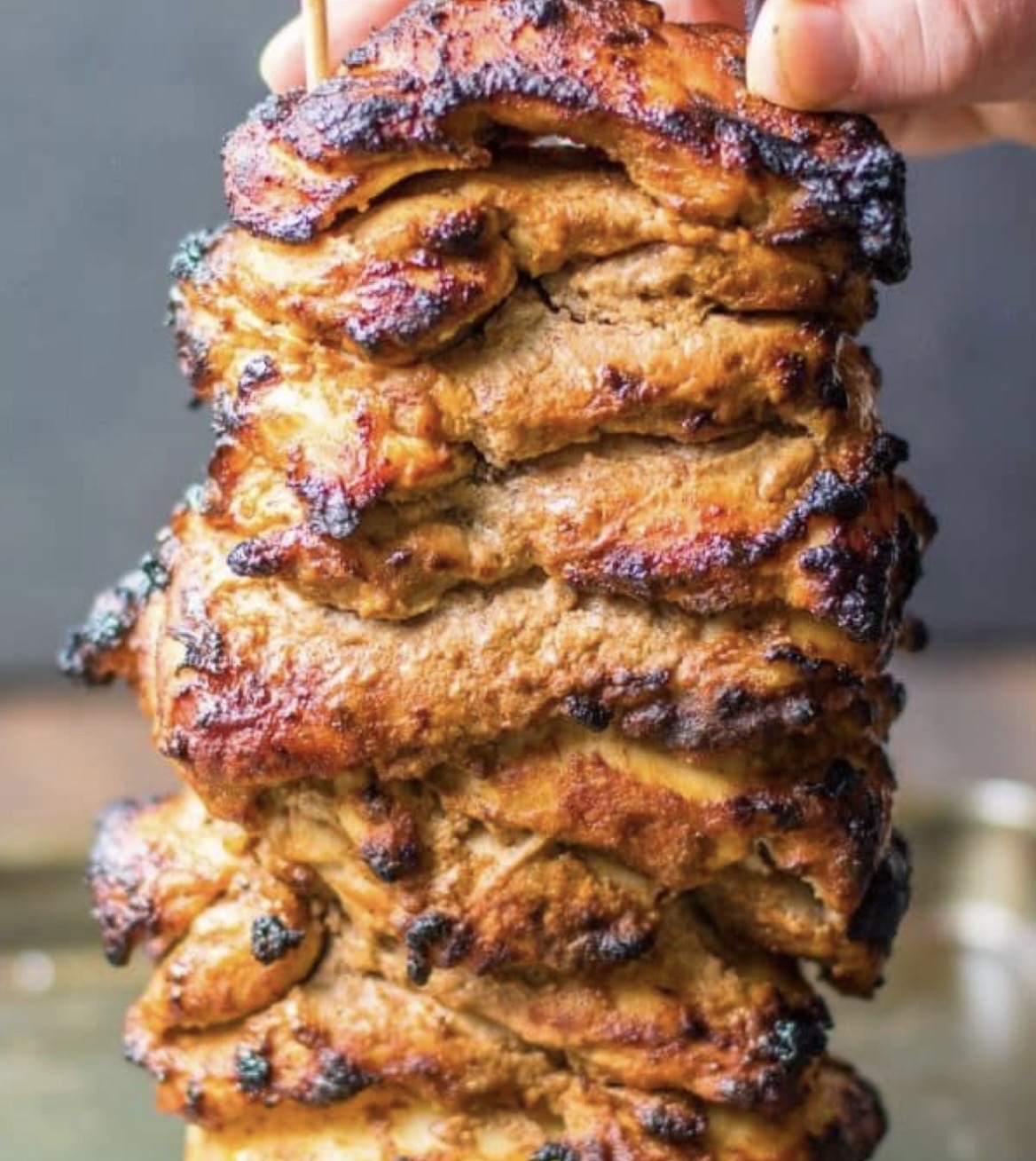 Marinated chicken shawarma stacked on the spit