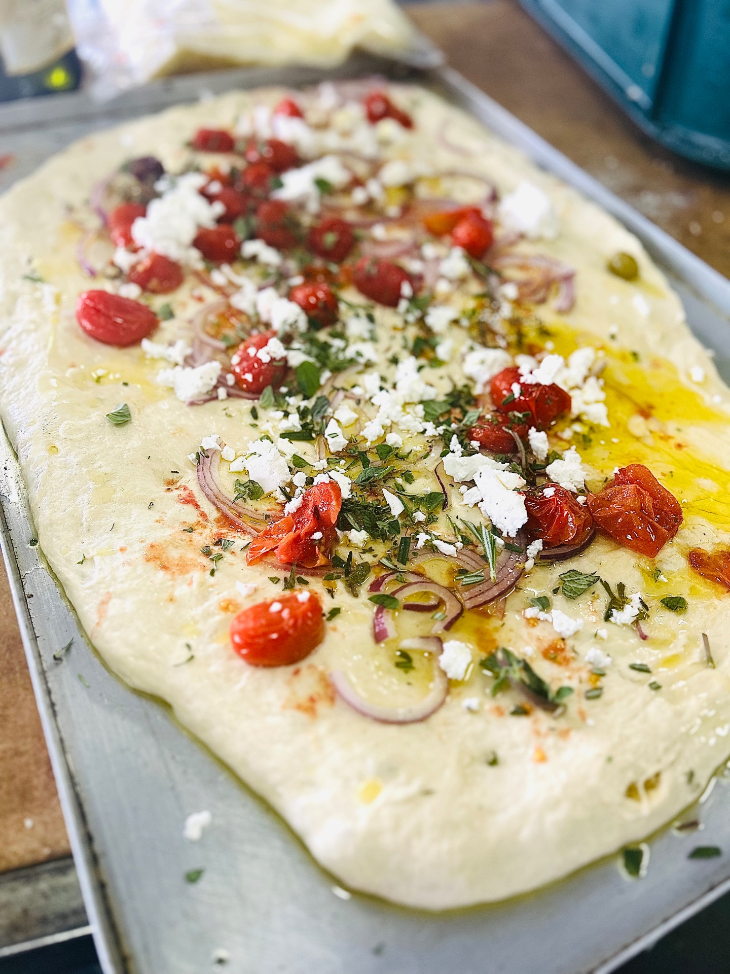Fresh focaccia with tomato, feta and herbs