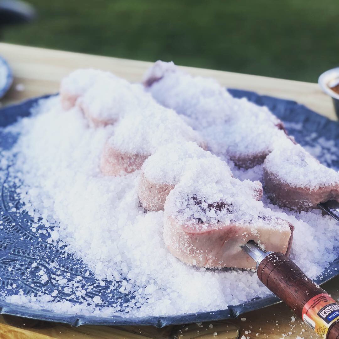 Salt-crusted lamb chops on stone platter